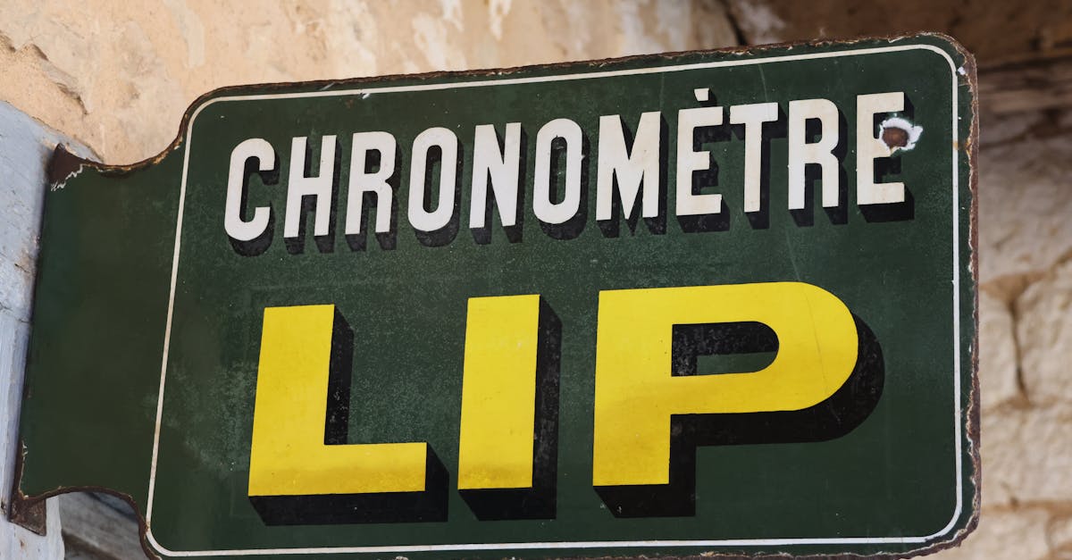 Old French wall-mounted sign reading 'CHRONOMÈTRE LIP' in bold letters against a rustic background.