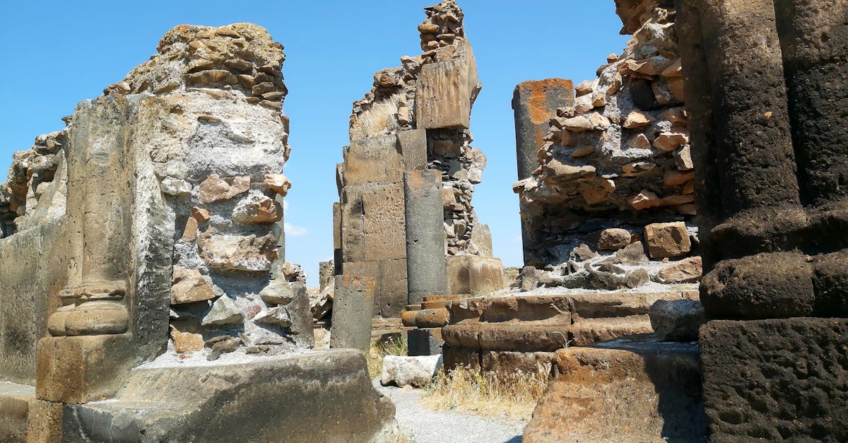 Explore the ancient ruins under a clear blue sky, capturing historical architecture and timeless beauty.