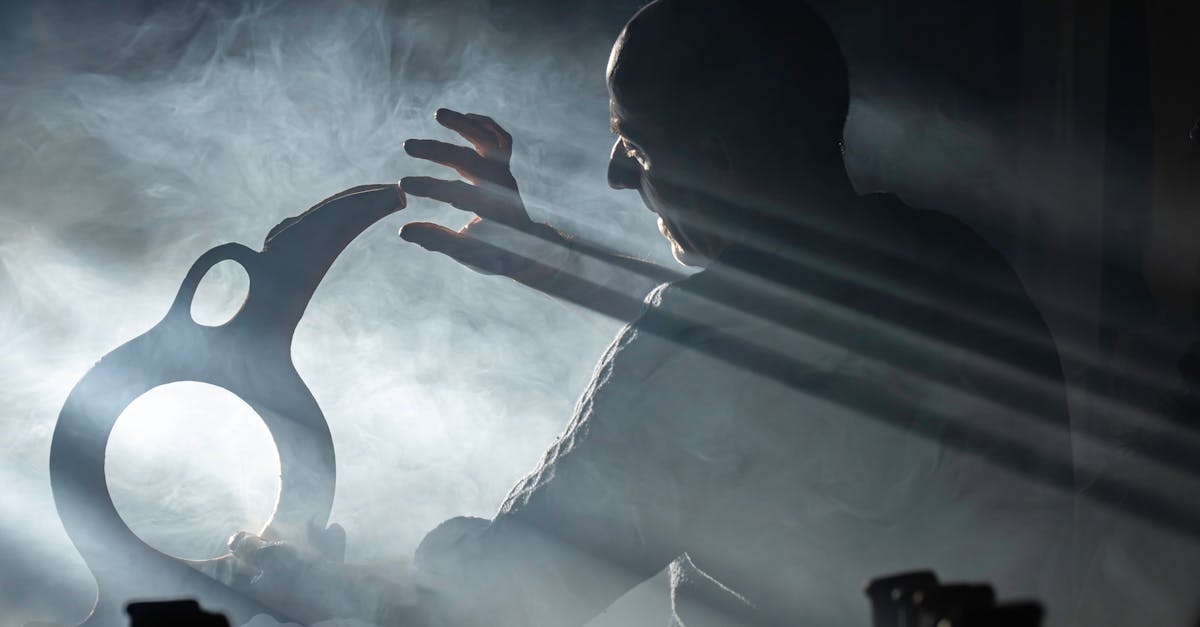 Silhouetted artisan crafting in dramatic lighting with fog and beams of light.