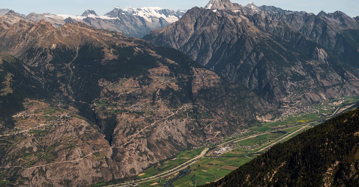 Panoramic view of Anniviers valley in Switzerland with majestic Swiss Alps under a clear blue sky.