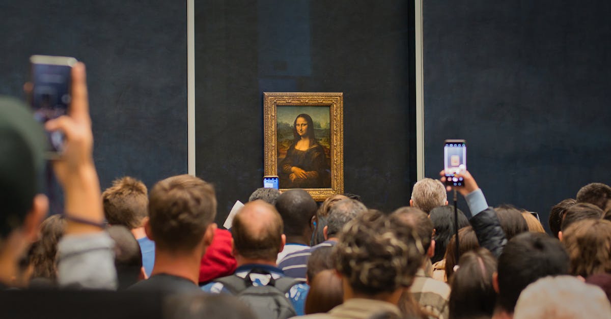 Tourists capturing the iconic Mona Lisa painting at the Louvre Museum.