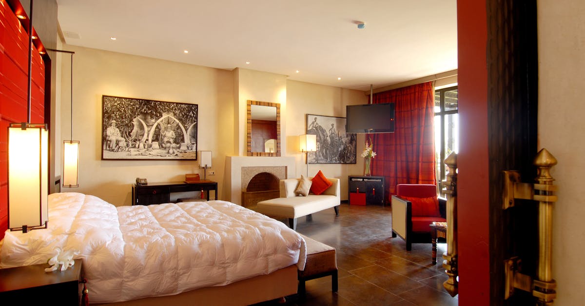 Elegant hotel room featuring modern design, warm lighting, and comfortable furnishings.