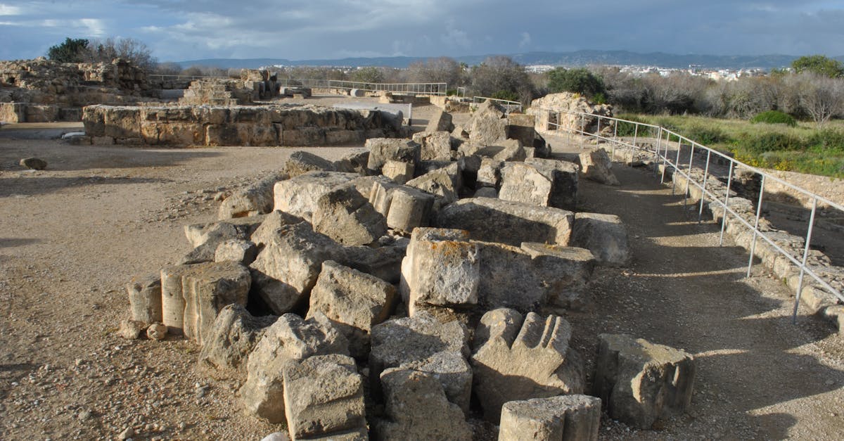 Scenic view of ancient ruins with fragmented stone columns and overcast skies.