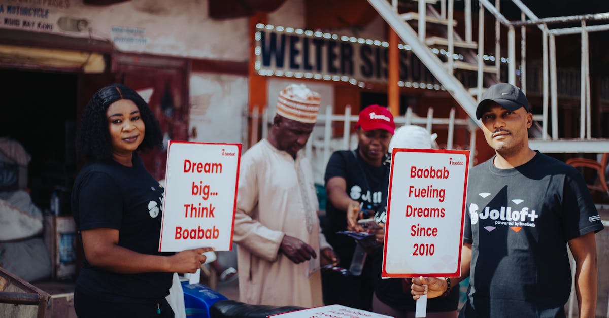 Group promoting Baobab in the street, holding motivational signs in Kano, Nigeria.