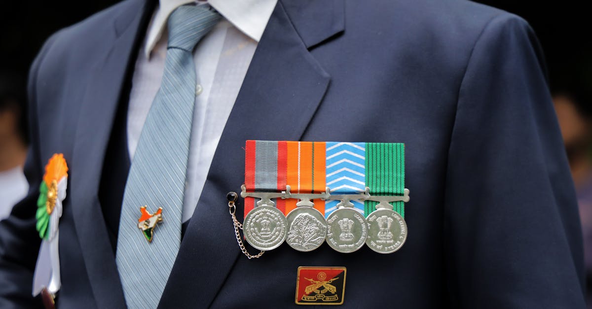Close-up of an Indian military ceremonial uniform with medals and Indian flag pin