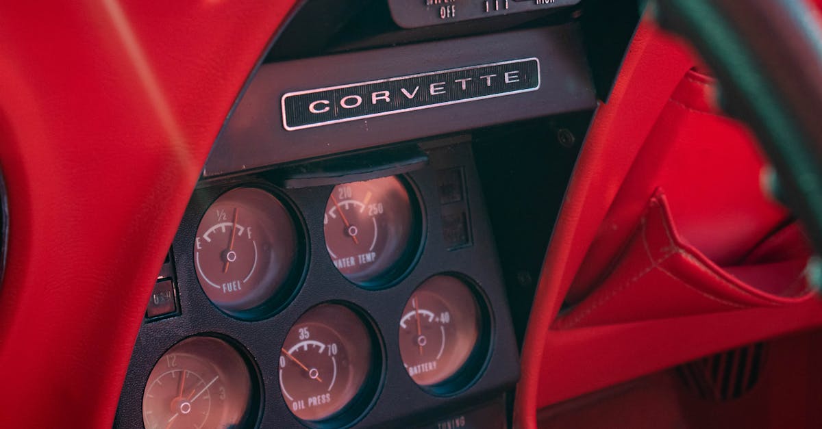 Close-up of a vintage Chevrolet Corvette dashboard showcasing gauges and details.