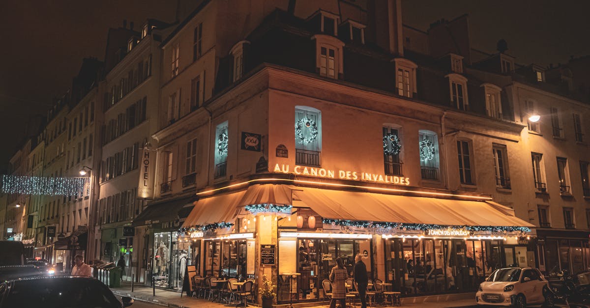 Cozy evening scene at a Parisian cafe with warm lights and decor.