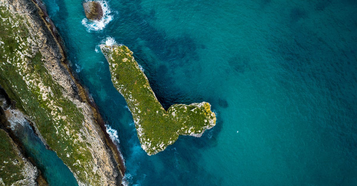 Explore the stunning aerial view of a rugged coastline across the vibrant blue waters of Spain.