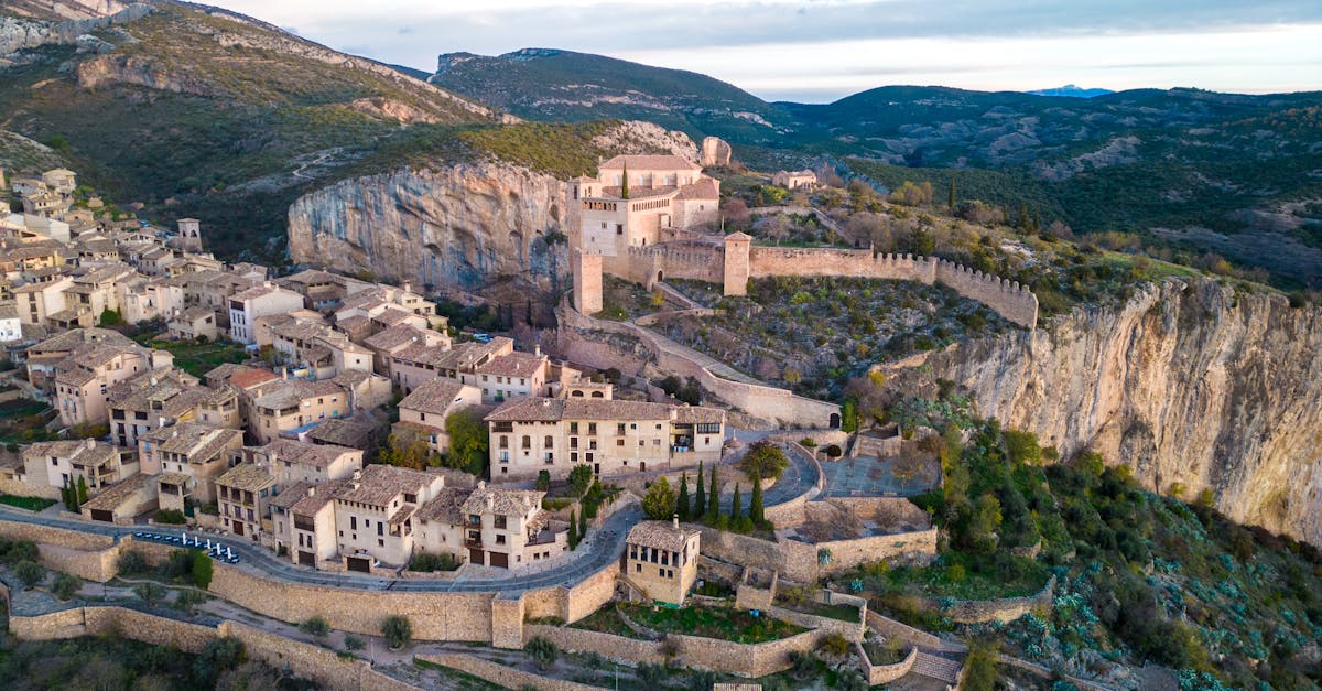 Breathtaking aerial view of Alquézar village and castle in Aragón, Spain, surrounded by mountains.