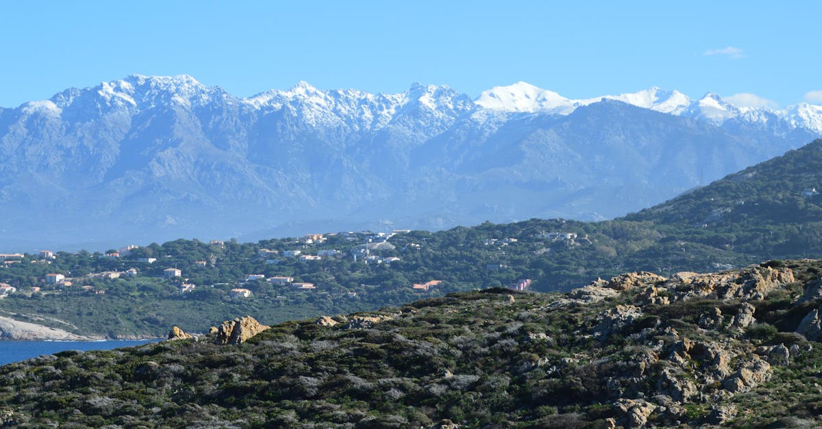 Beautiful snow-capped mountains and rugged hills viewed from Calvi, Corsica, France.