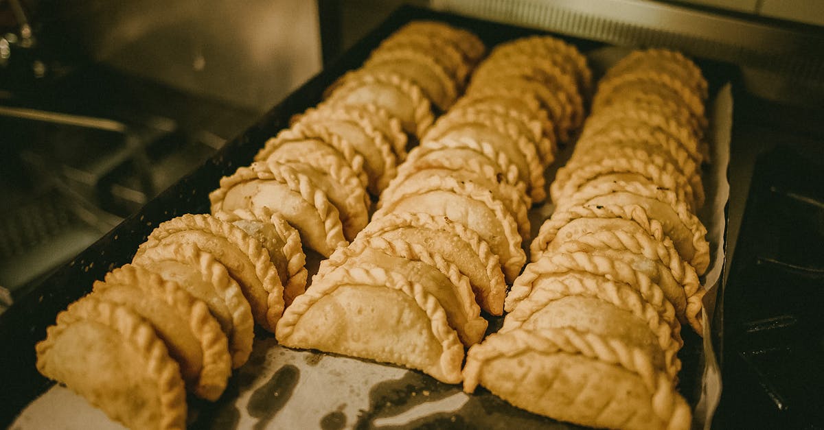 A tray of golden-brown empanadas fresh from the oven, perfect for food lovers and culinary enthusiasts.