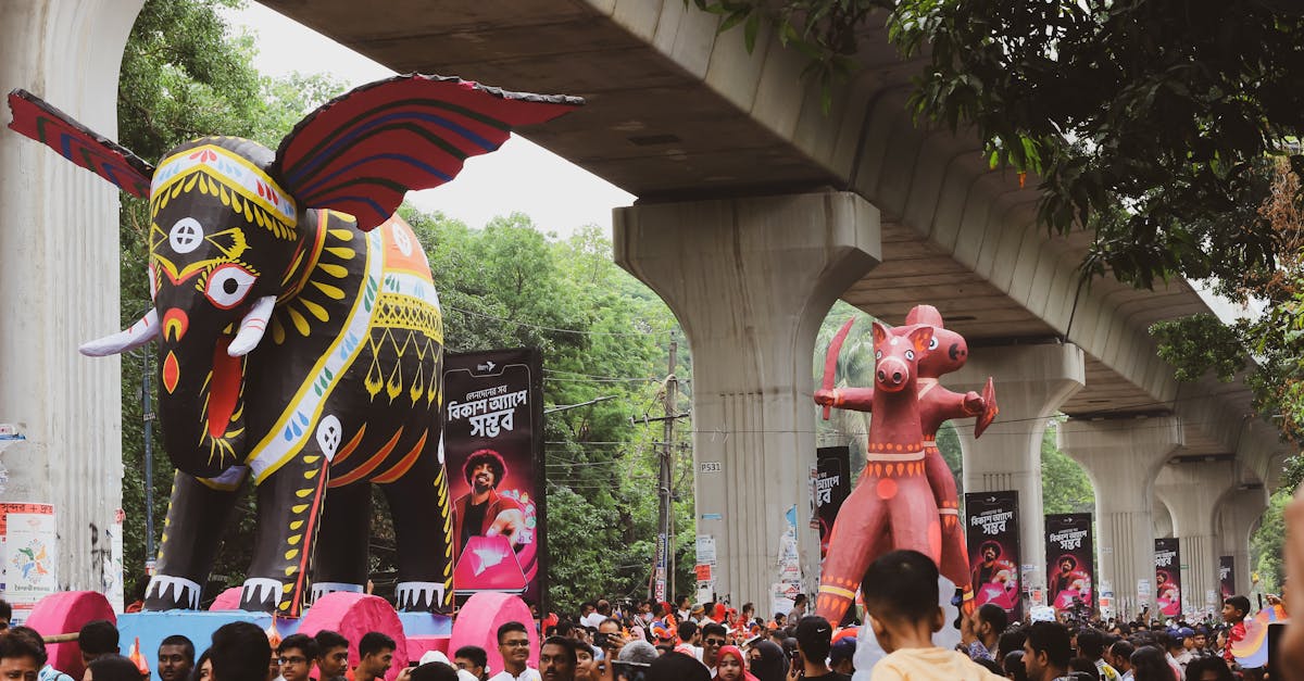 Colorful celebration with large artistic elephant figures at a carnival in Dhaka, Bangladesh.