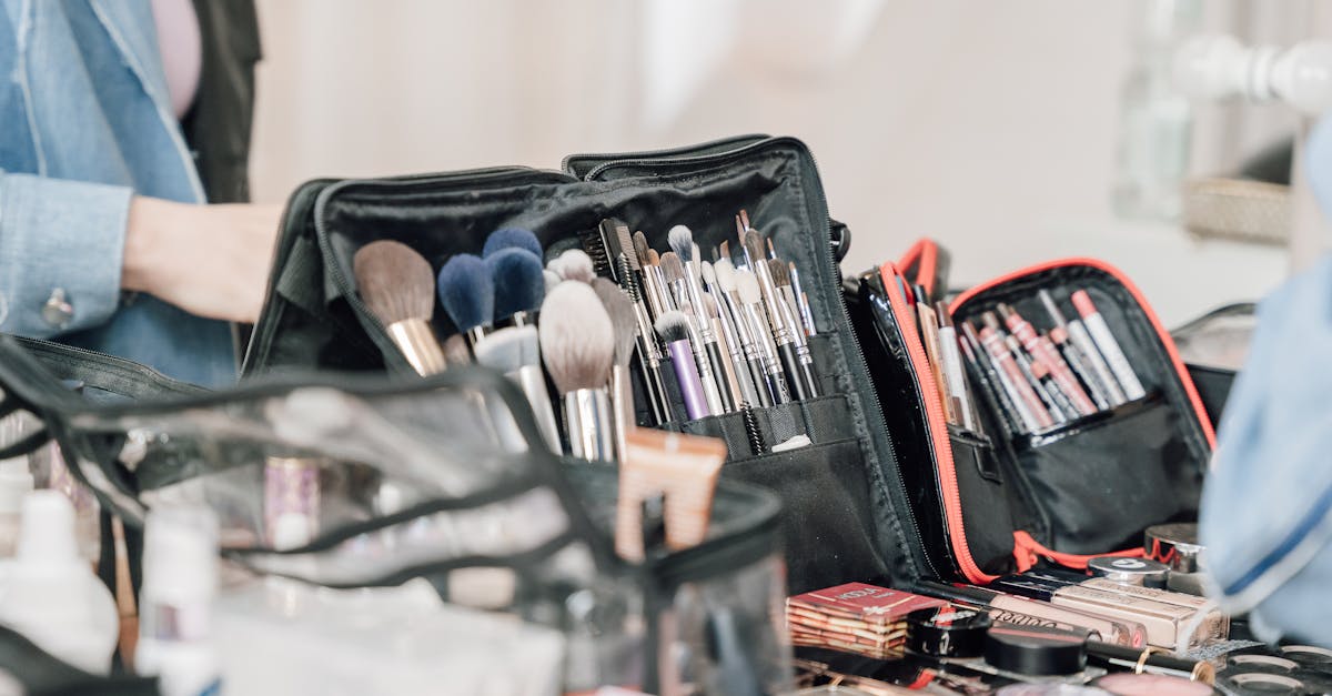 A variety of makeup brushes and tools arranged in bags on a table, ready for professional use.