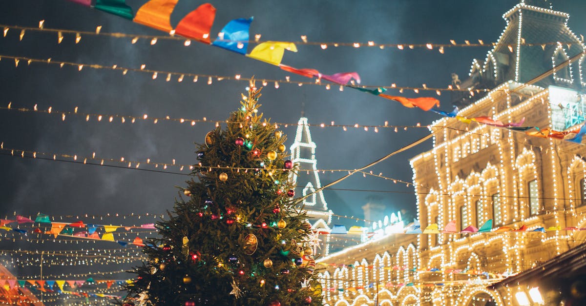 Vibrant Christmas market scene featuring a decorated tree and twinkling lights at night.