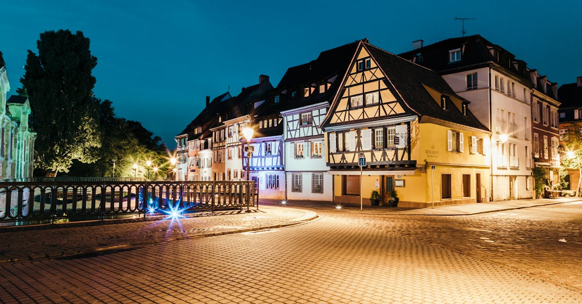 Scenic night view of traditional Alsatian houses in Colmar, France, beautifully lit and serene.