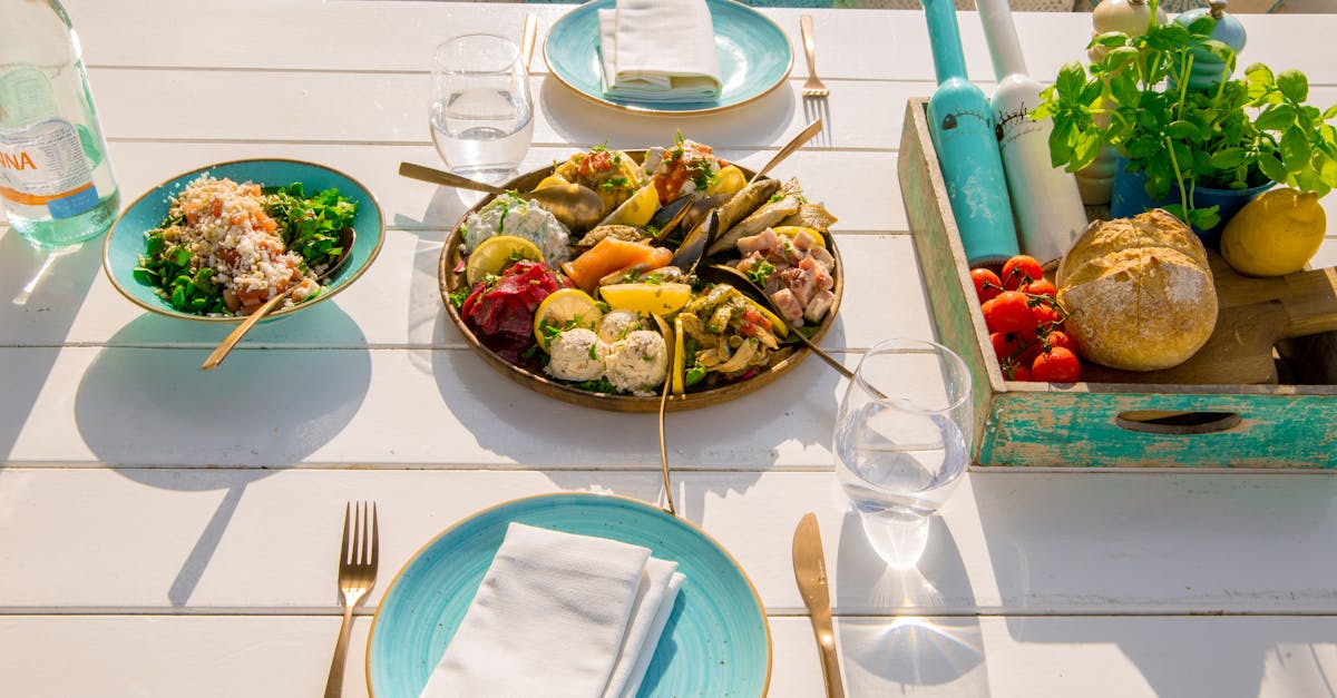 A beautifully arranged seafood platter and fresh salad on an outdoor patio table set for dining.