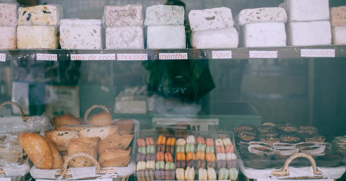 Assorted yummy sweets and bakery products places on counter of confectionery shop in daytime