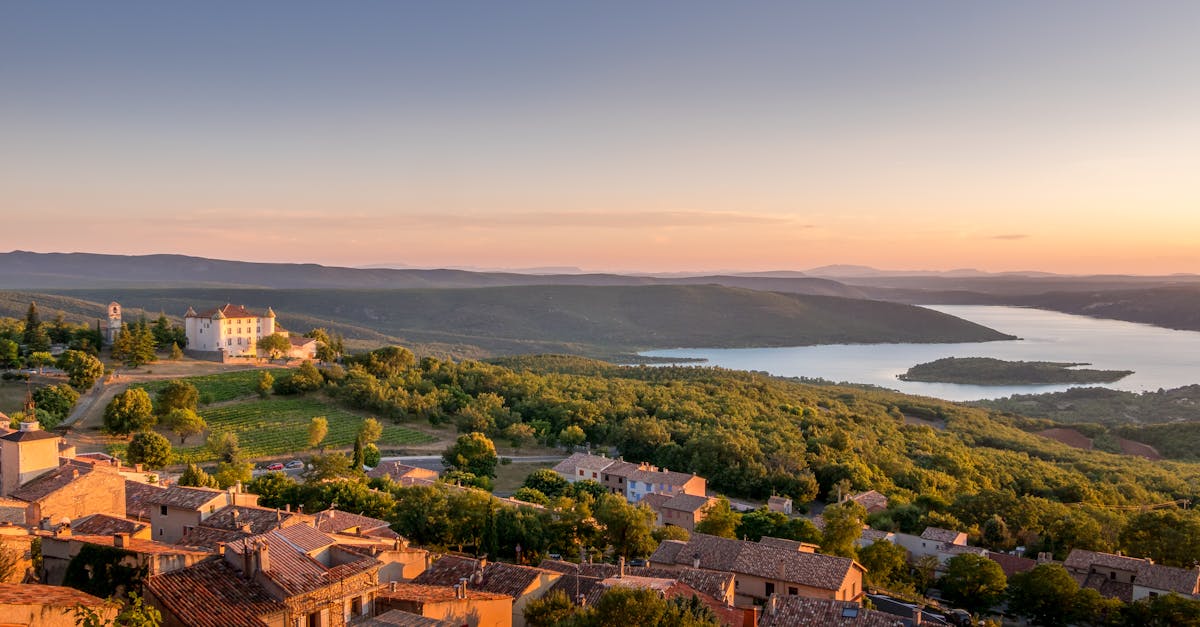 Captivating view of Aiguines village and lake during sunset in Provence-Alpes-Côte d'Azur, France.