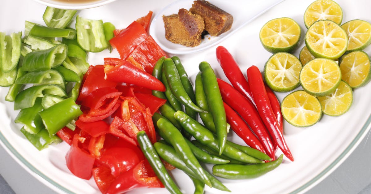 Close-up of colorful fresh ingredients on a ceramic plate, ready for Malaysian cooking.