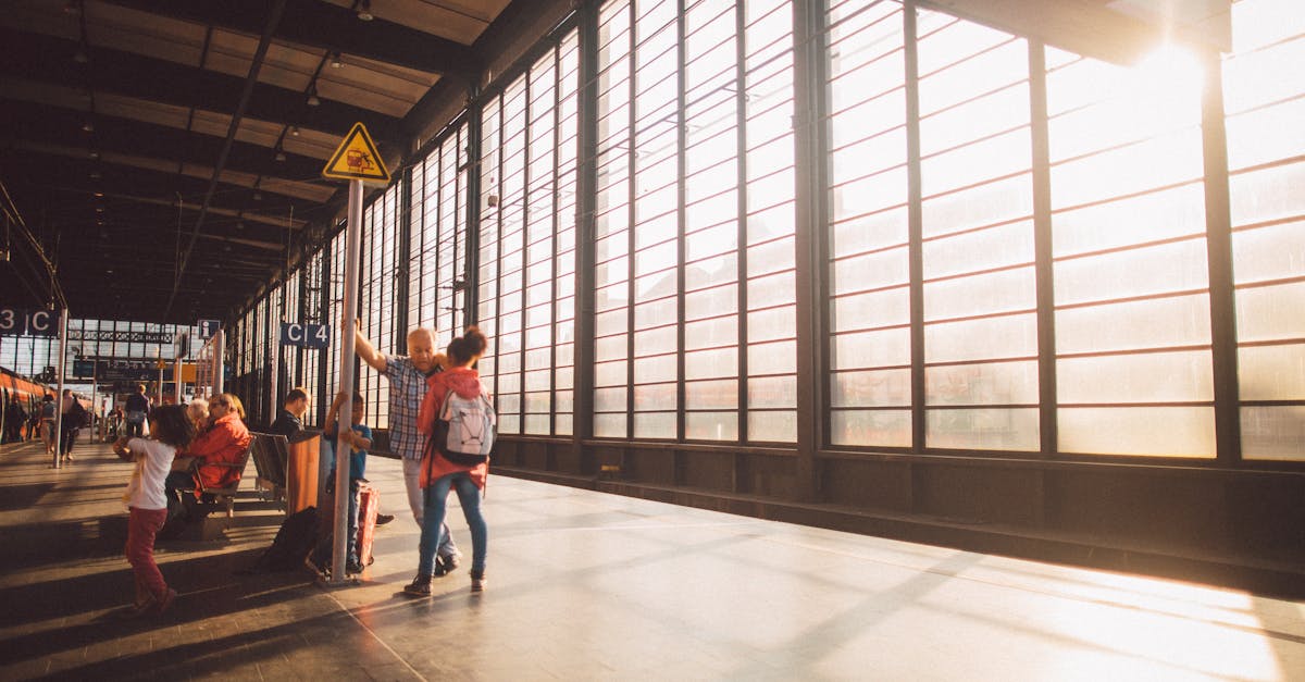 A vibrant moment at a Berlin train station with warm sunlight streaming through large glass windows.