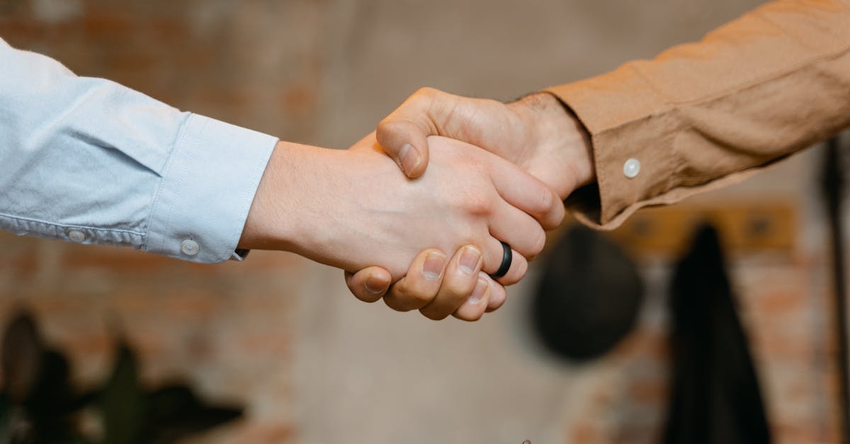 Close-up of a firm handshake symbolizing a business deal agreement.