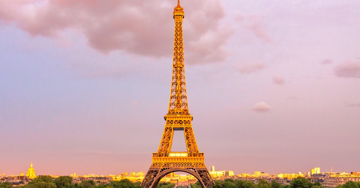 Capture of the Eiffel Tower in Paris at dusk with a vibrant sky, showcasing its iconic structure.