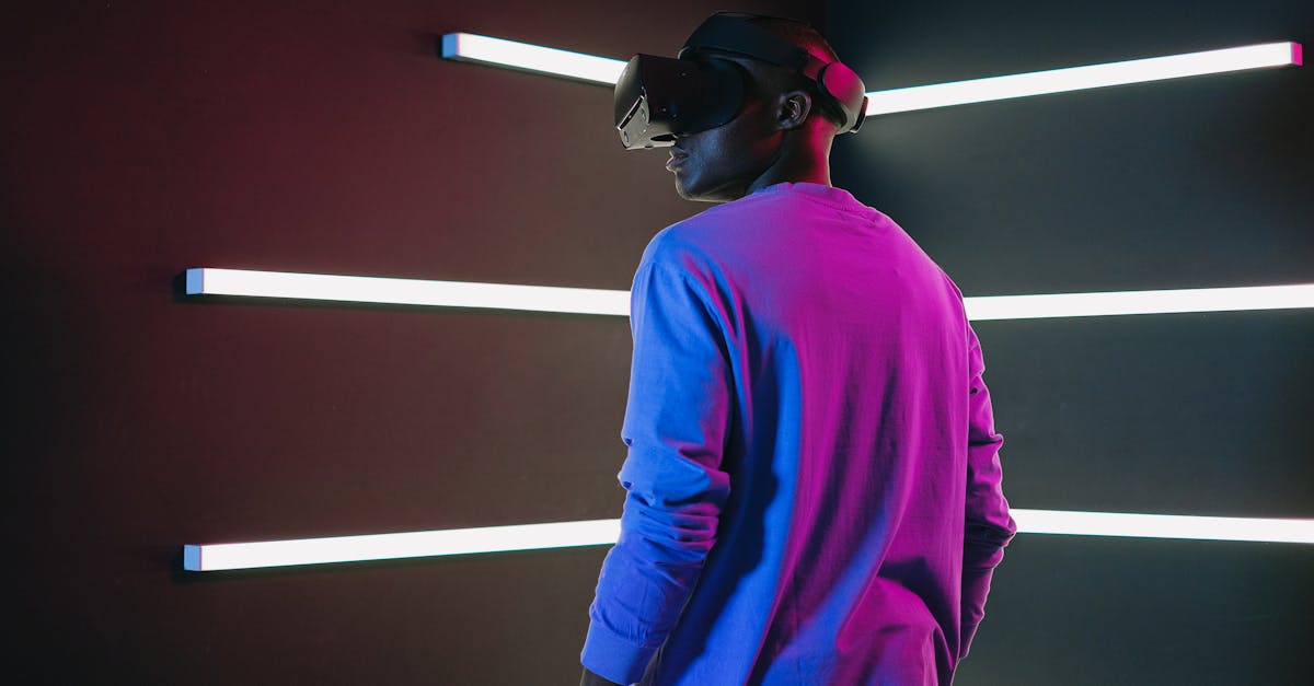 Man using VR headset in a room with vibrant neon lights and modern technology ambiance.