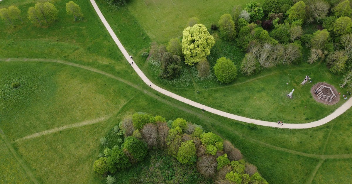 A captivating aerial view of a lush green park with winding paths and dense tree coverage in Houghton Regis, England.