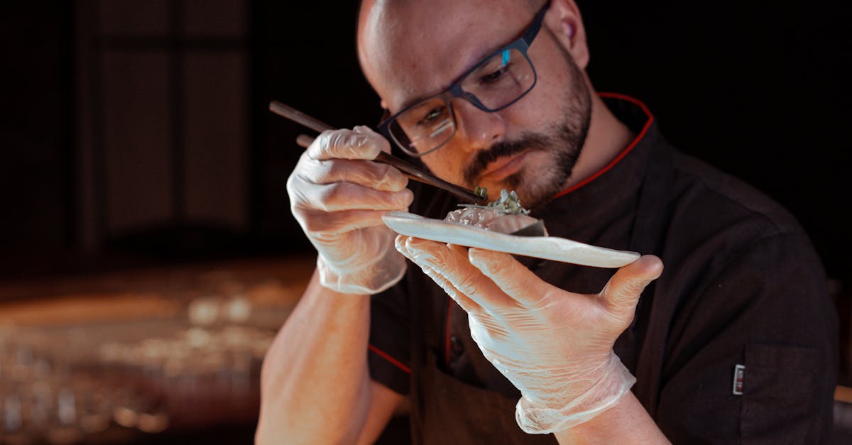 Chef intricately garnishing a gourmet Asian dish, focusing on precision and detail.