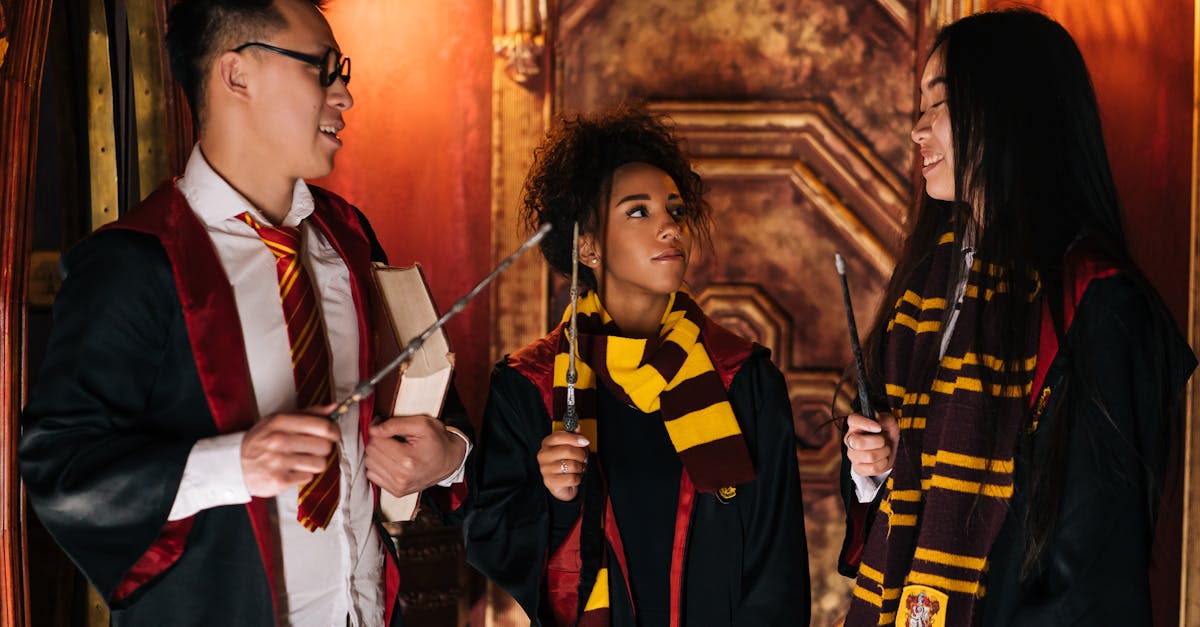 Friends dressed in magical costumes with wands and scarves sharing a moment indoors.