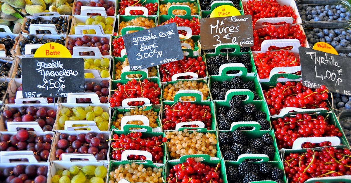 A vibrant display of assorted berries for sale at a market in Le Bois-Plage-en-Ré, France.