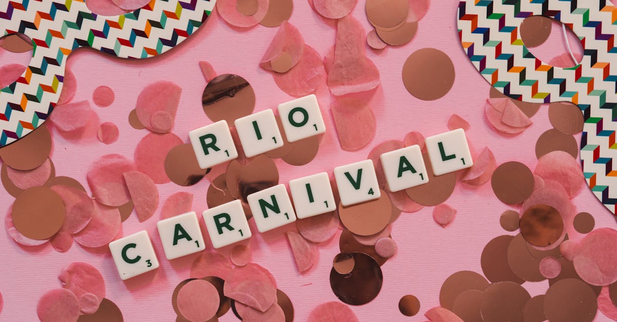 Top view of a colorful Rio carnival mask with confetti on a pink surface, highlighting festive vibes.