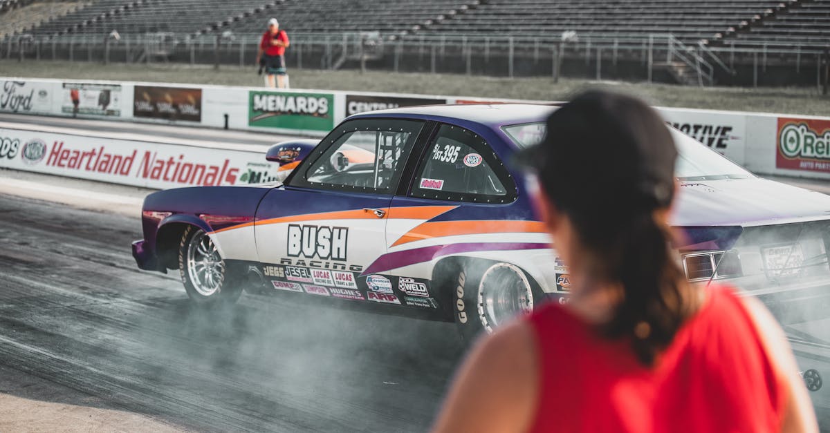 A thrilling drag race event at Heartland Nationals in Topeka, showcasing modified race cars and dynamic competition.