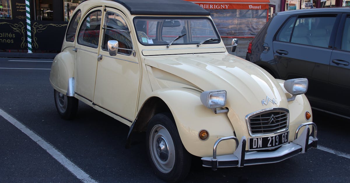 Vintage Citroen 2CV parked outdoors, showcasing classic design in an urban setting.